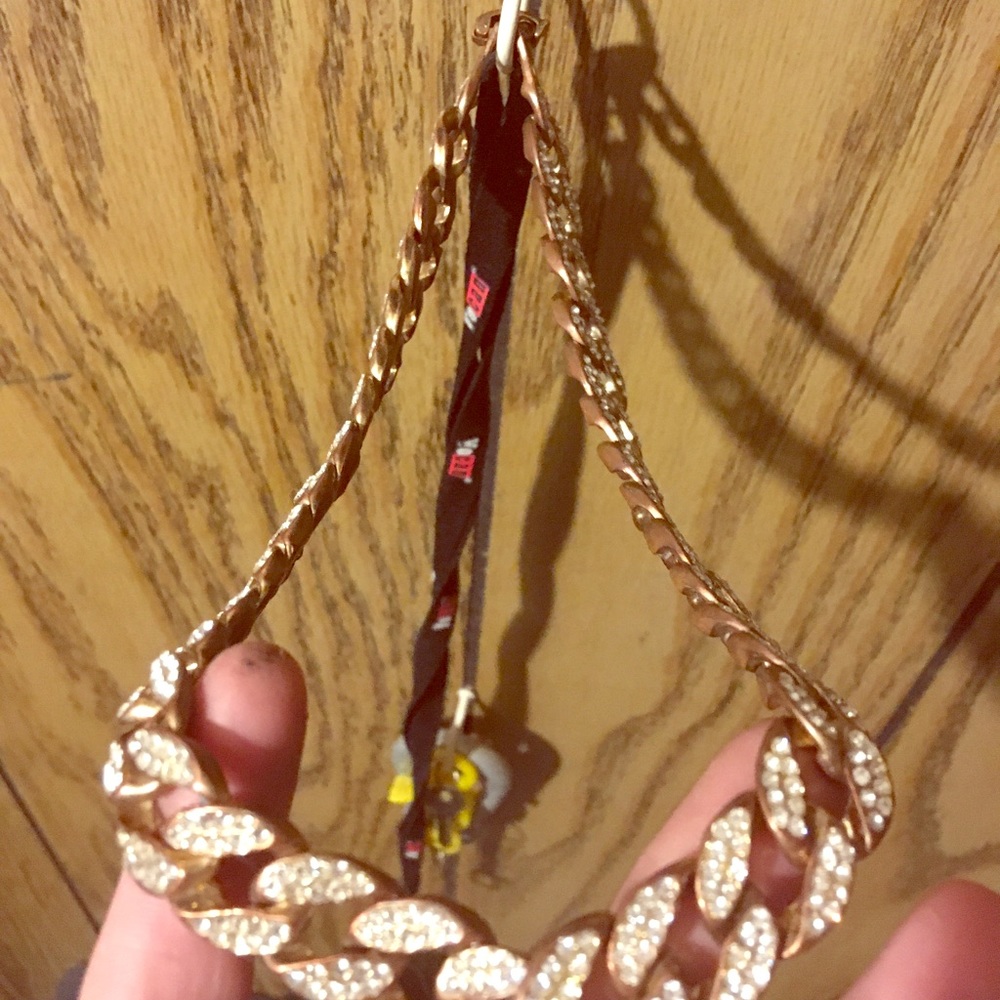 2 blinging necklaces one golddiamond other skull